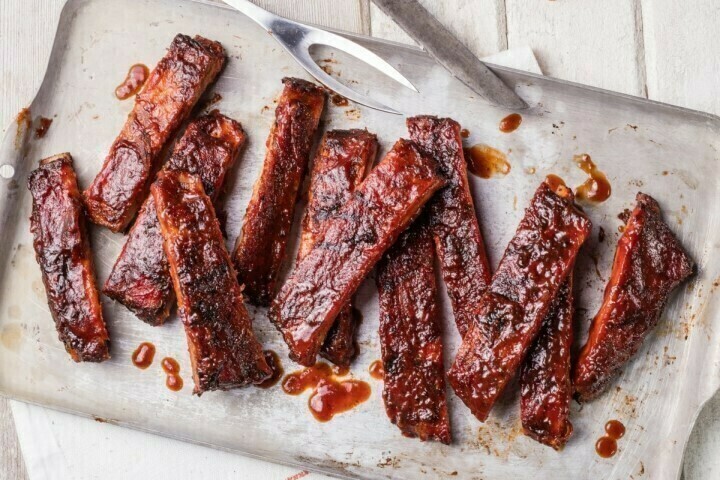 Chicken drumstick and bottle of barbecue sauce, found at Famous Dave's fundraisers